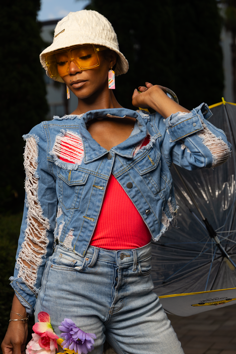 a woman wearing sunglasses holding a umbrella