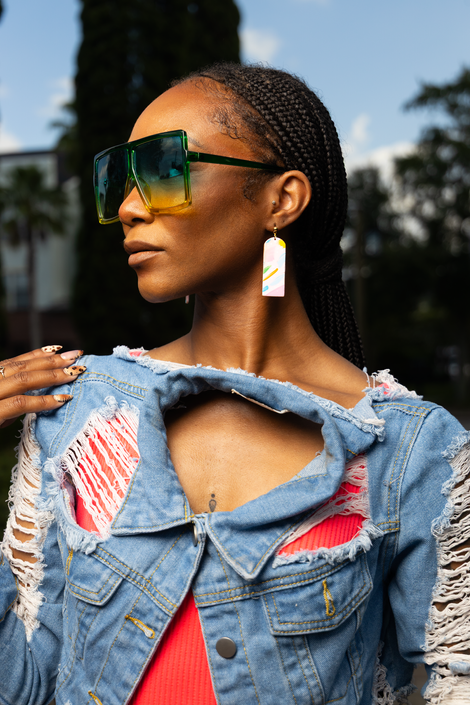 a woman wearing sunglasses looking over shoulder