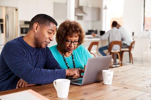 Middle aged black man helping his mother