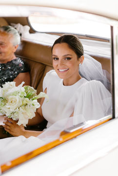 Katherine Denton holds her a petite bridal bouquet with orchids and calla lilies