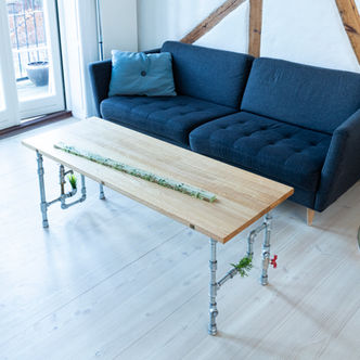 Incy Wincy Spider oak coffee table with an inserted clear bar of leaves cast in epoxy. Legs of steel pipes