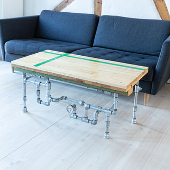 Viby Hallen coffee table made of sports hall flooring with green court stripes. Creative steel pipe legs