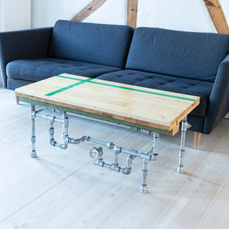 Viby Hallen coffee table made of sports hall flooring with green court stripes. Creative steel pipe legs