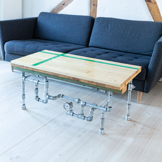 Viby Hallen coffee table made of sports hall flooring with green court stripes. Creative steel pipe legs