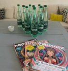 Bottles of water and magazines arranged in a relaxed lounge area