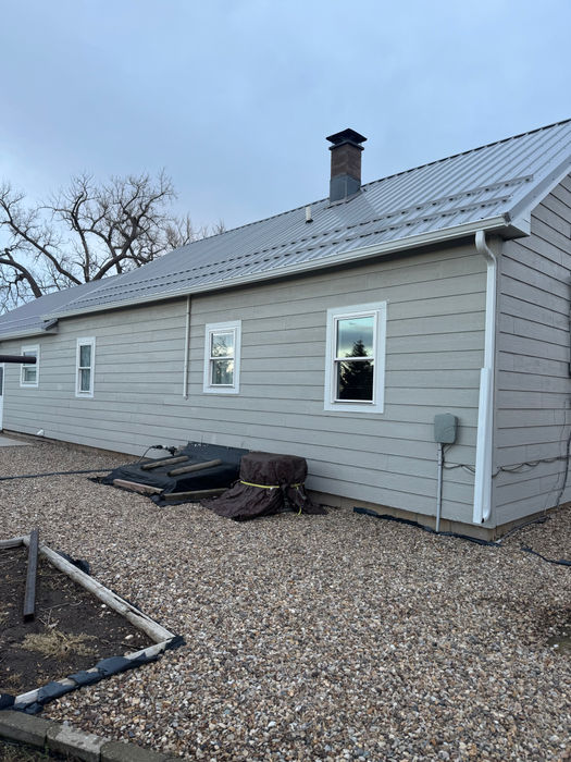 Finished seamless gutter installation with matching downspouts on a Black Hills residence.