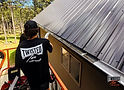 Twisted Tin gutters being installed on a building.