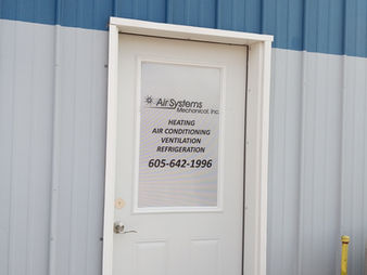 White door with Air Systems Mechanical, Inc. details including phone number on window perf.