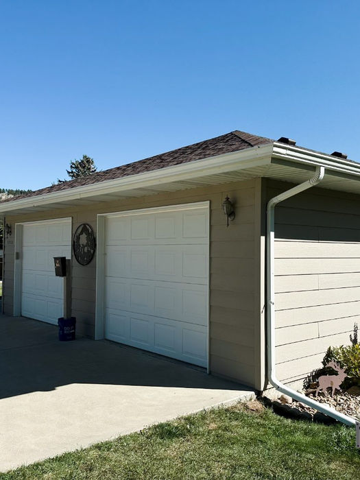 Finished seamless gutter installation with matching downspouts on a Black Hills residence.