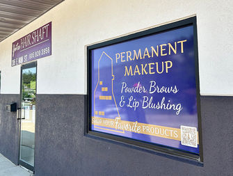 Permanent Makeup sign on a window with Powder Brows and Lip Blushing.