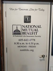 White door with National Mutual Benefit information and contact details on it.