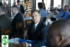 Business man at event with logo.jpeg