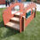 Thumbnail: low toddler stairs with terra cotta red sides and pull up bar with multi colored accents and mirror at daycare school