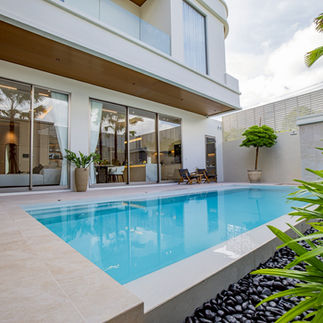 Private salt-system pool villa for sale Pattaya with tropical landscaping and terrace access.