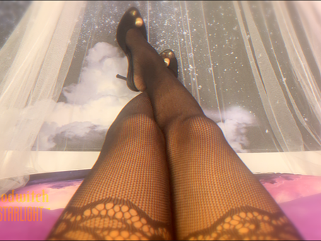 POV shot of Goddess Godwitch's long ebony legs in fishnets. Designer heels and golden pedicure.