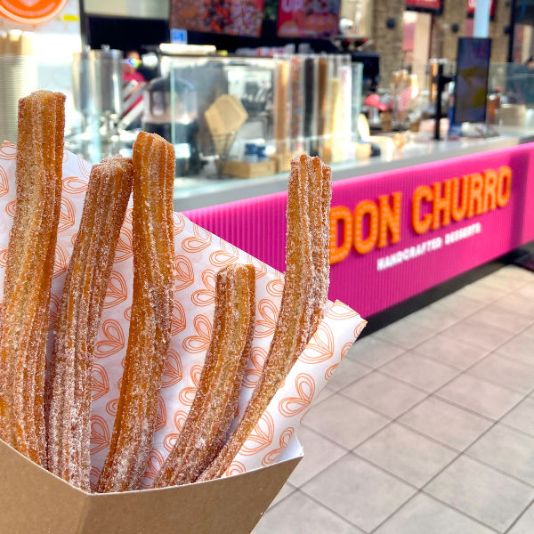 Close-up view of freshly made churros coated in cinnamon sugar