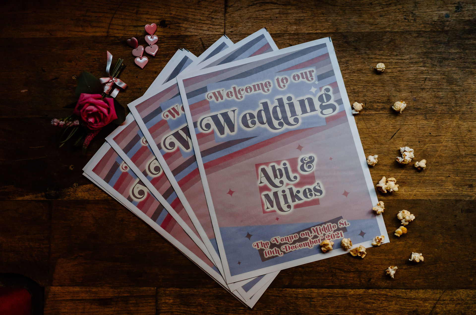 Pink and purple wedding newspaper ideas. Photo by Leesha Williams Photography.