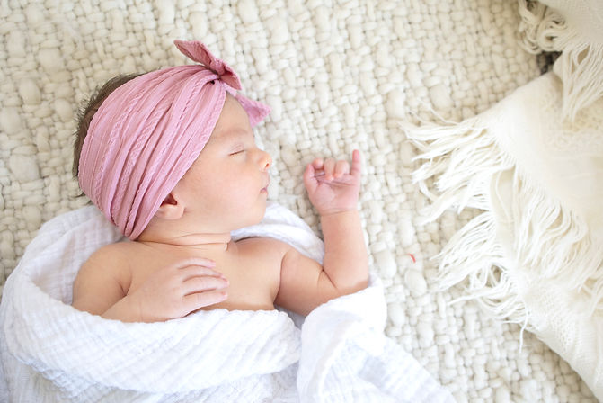 Adorable newborn girl sleeping comfortably