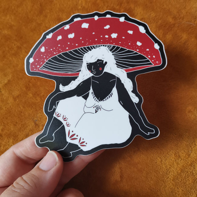 woman sitting down with mushroom head on black sticker.