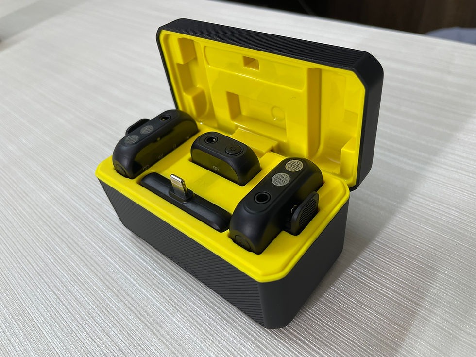 Black and yellow case open, revealing small electronic modules inside.