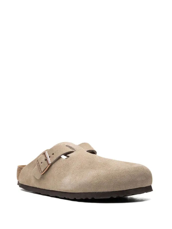 Single light beige suede Birkenstock style clog shoe, side view.