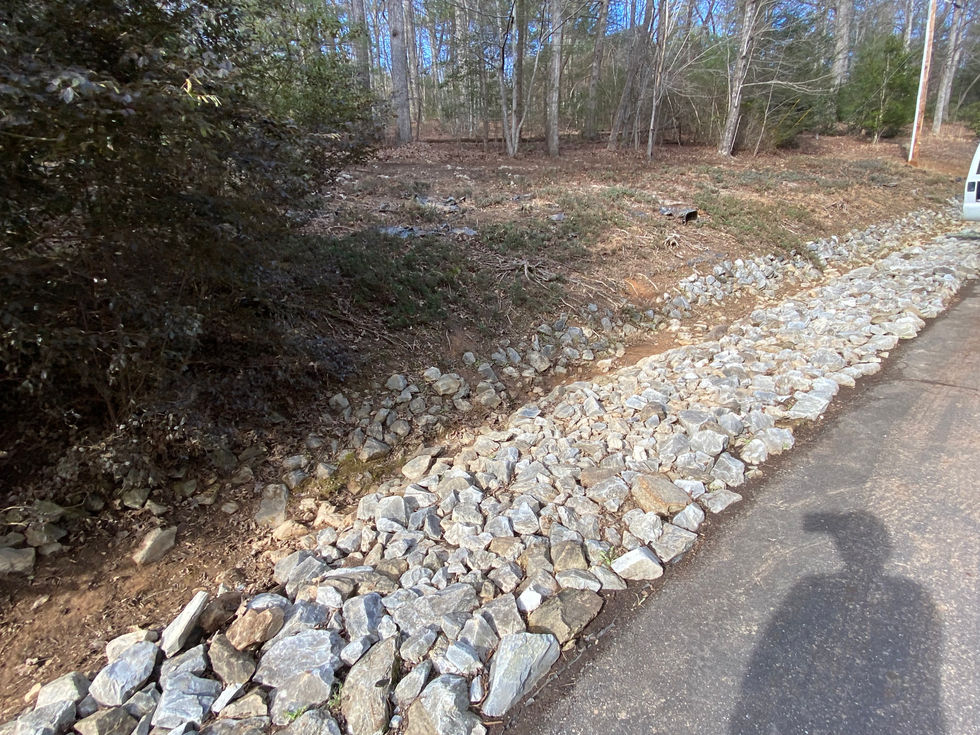 Seasonal cleanup of large rock drainage and surrounding area