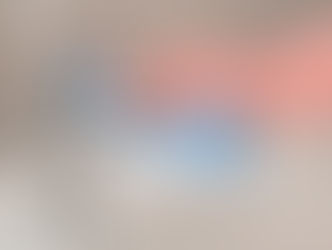 Cleaning limescale from a chrome tap using a cloth and gloves in a bathroom sink