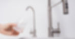 Hand filling a glass from a modern water filter tap, representing Waterdrop reviews on customer service, aftercare and water quality