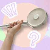 Hand holding a shower filter against a pastel abstract background with question mark graphics, representing things to consider before buying a shower filter for hard water.