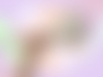 Hand holding a shower filter against a pastel abstract background with question mark graphics, representing things to consider before buying a shower filter for hard water.