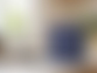 FlowPure water filter box on a kitchen countertop next to a sink and tap in a bright modern kitchen