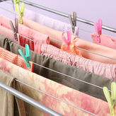 Clothes drying on a rack indoors, illustrating stiff laundry caused by hard water