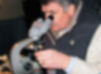 Phil examining a specimen through a microscope