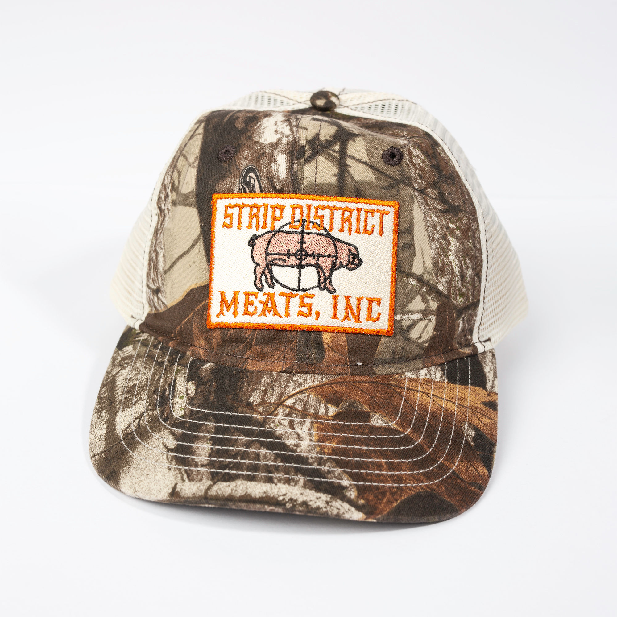 Camo Trucker hat with a patch on the front. Patch has the company name and a pig on it.