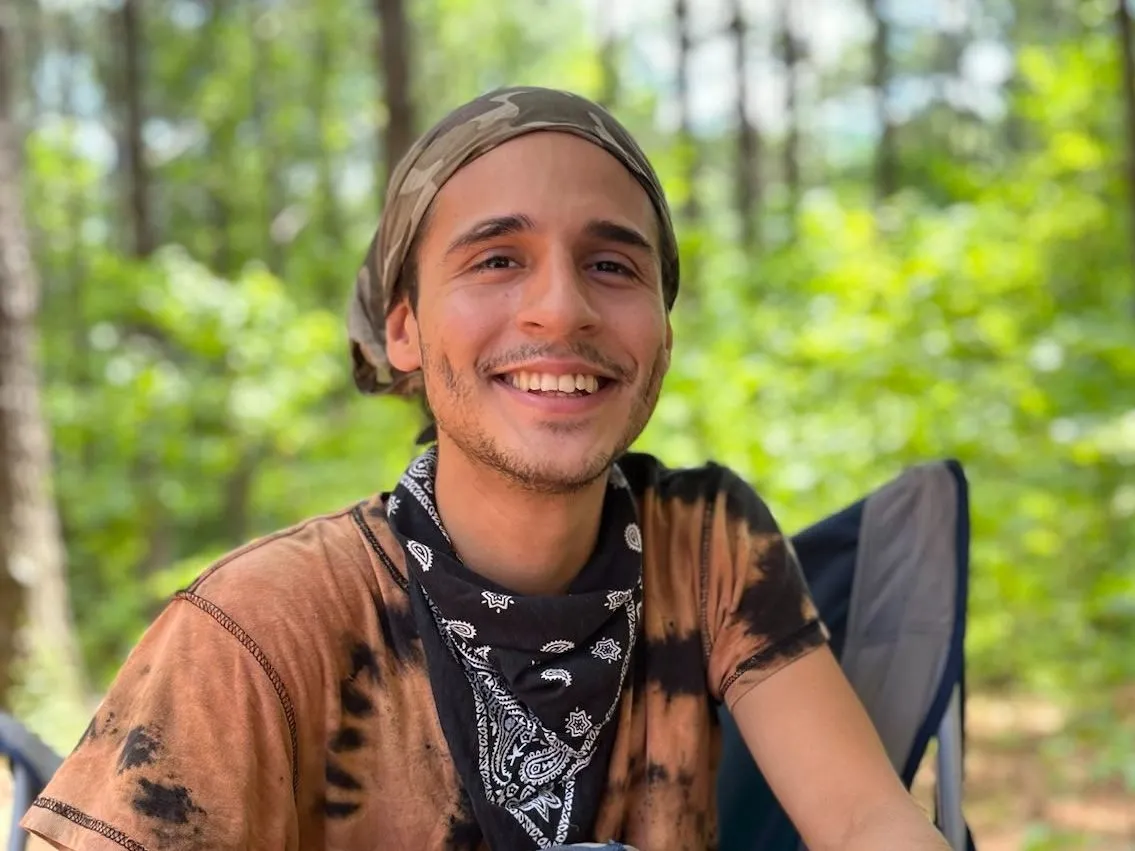 Manuel Paez Terán smiling in forest