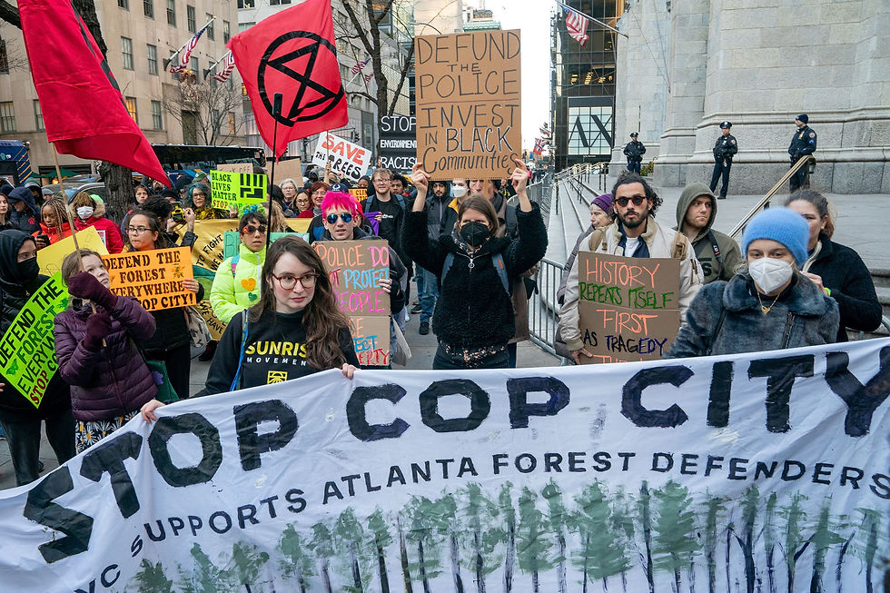 Protestors holding a banner that reads "Stop Cop City"