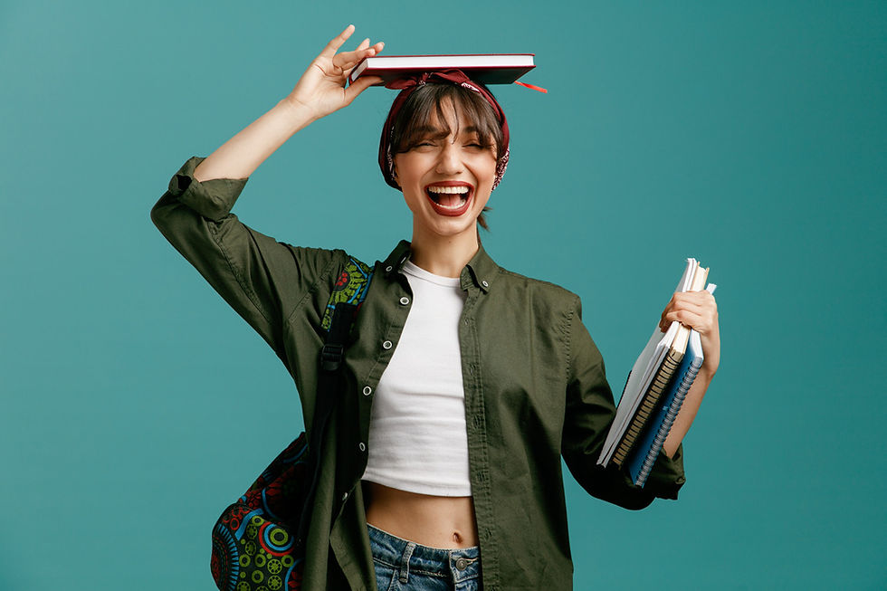 Smiling woman with notebooks on head and in hand against a blue background.