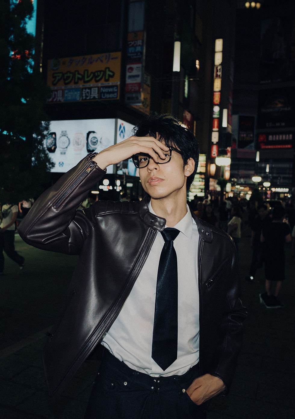 Man in leather jacket at night by a Tokyo Photographer.