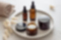 Cosmetics packaging. Set of different cosmetic bottles of cream or serum on a ceramic tray