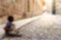 Refugee from the Middle East on the street of European city. Focus on the boy..jpg