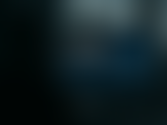 Silhouetted person viewing AI-driven sales analytics on a computer screen displaying ERP system dashboards with charts, graphs, and predictive insights, representing the integration of AI sales insights into ERP systems in a modern office setting at twilight.