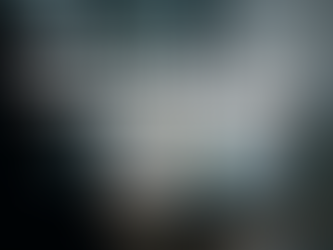 Ultra realistic image of a modern office with a computer monitor displaying colorful sales graphs, bar charts, and pie charts for seasonal sales trends and machine learning adjustments, with a silhouetted faceless person analyzing data in the foreground — representing advanced seasonal sales prediction with machine learning in business environments.