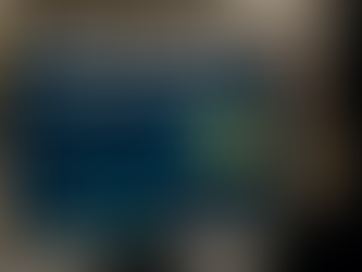 Retail store computer screen showing machine learning dashboard with foot traffic prediction graphs, heat map of in-store visitor zones, and daily visitor statistics for optimizing store performance