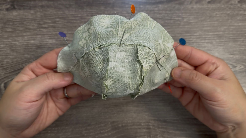 Pin around the edges. Make sure the ribbon ties are tucked safely inside so they do not get caught while sewing.