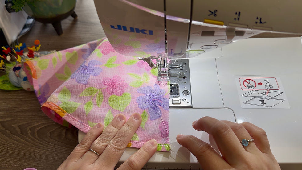 Stitch the back seam of the dress to close it.