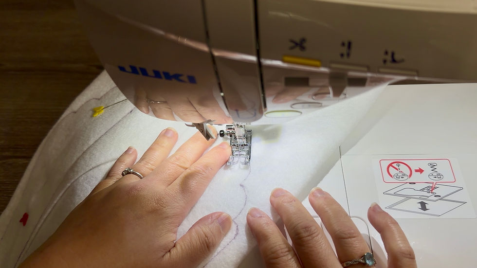 Starting at the marked center attachment seam allowance, stitch along the traced outline of each wing.