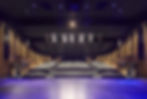 A large auditorium from the viewpoint of the main stage.