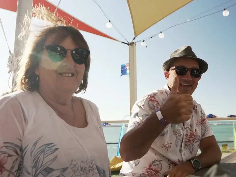 Smiling couple, man gives thumbs up
