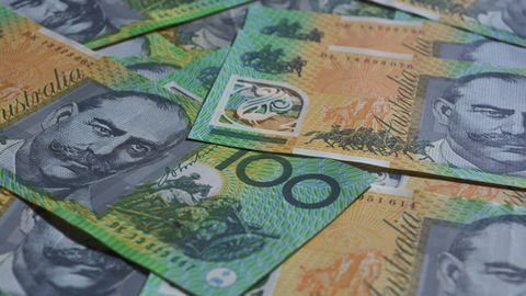 Close-up of Australian one hundred dollar banknotes spread out on a surface