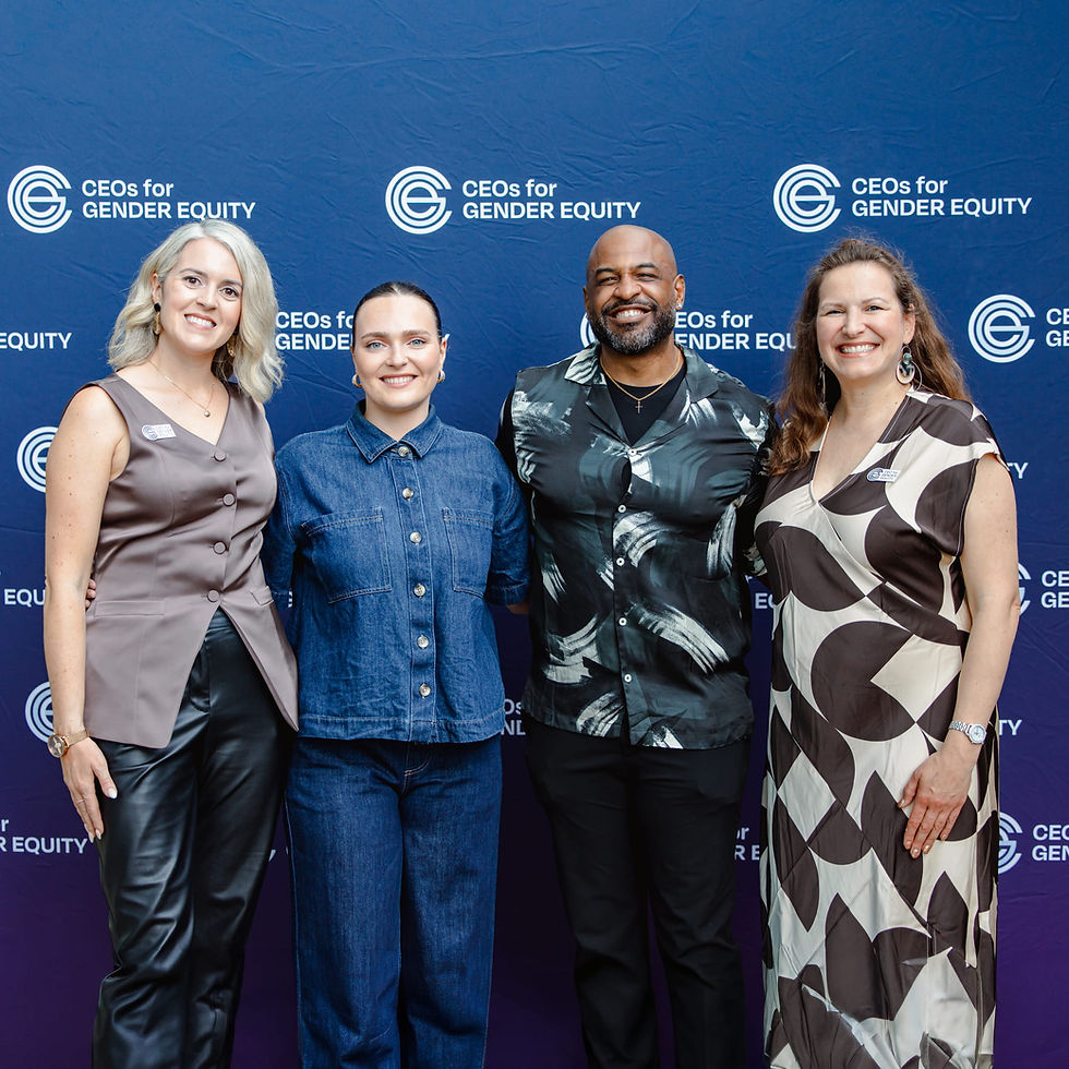Four smiling people at a CEOs for Gender Equity event.
